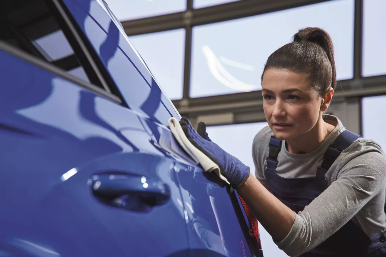 A Volkswagen accident damage specialist assessing a vehicle