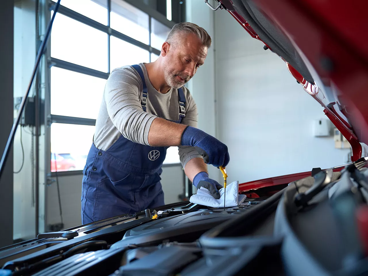 A Volkswagen technician carrying out an Oil Service