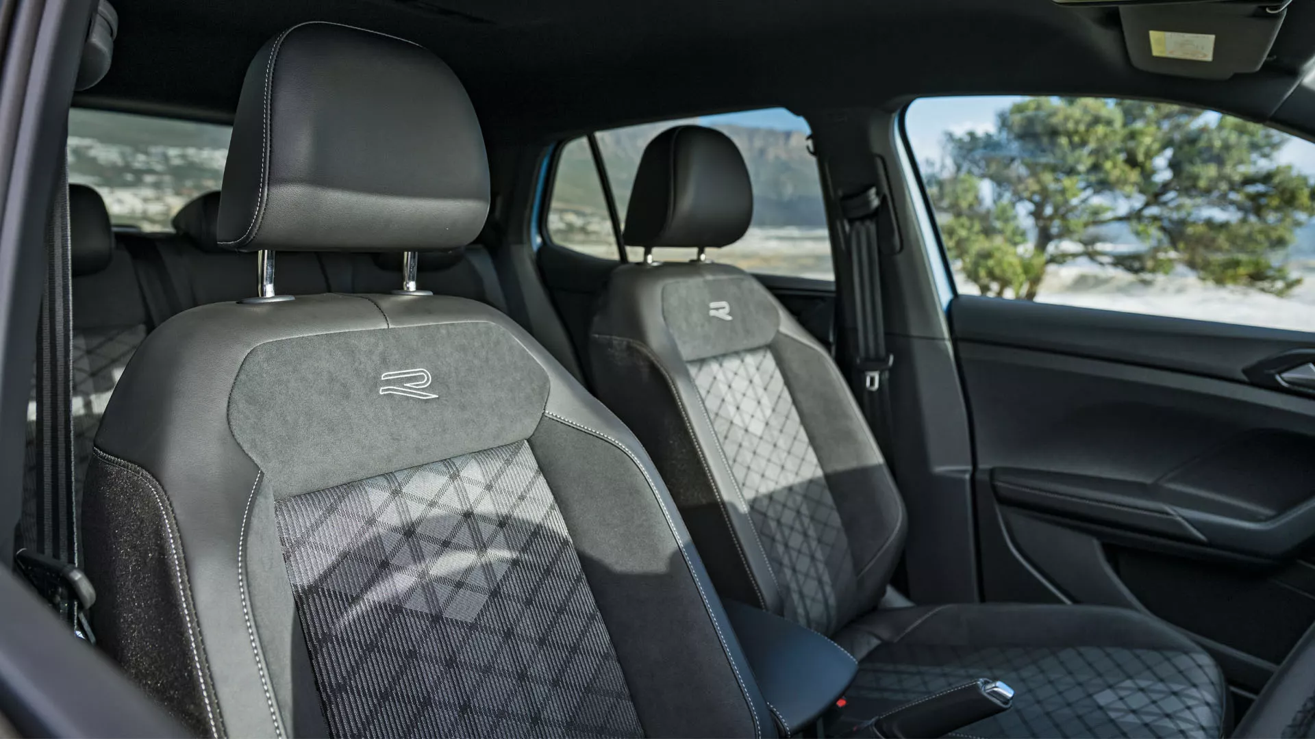 View of the front seats with the front doors open.