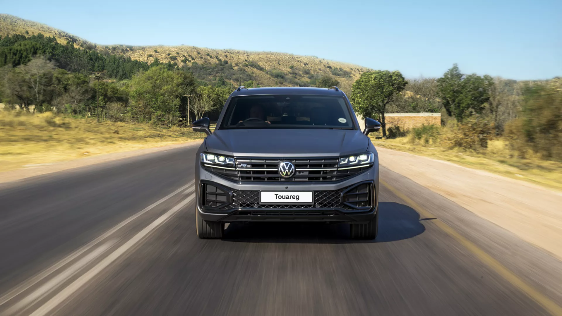 A VW Touareg R-Line parked at the roadside, diagonal view from the front.